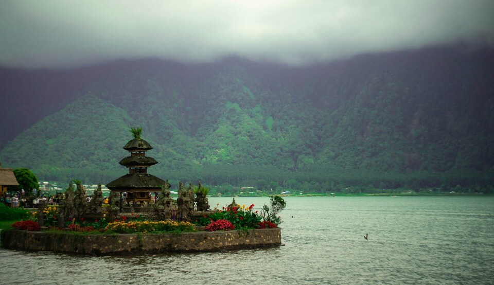 A temple on a lake with hills behind it