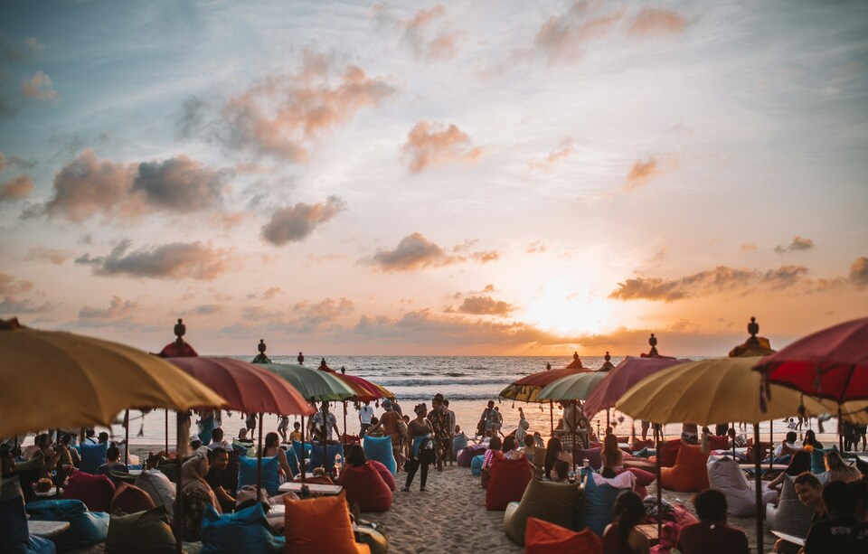 Sunset at a beach with lots of umbrellas 