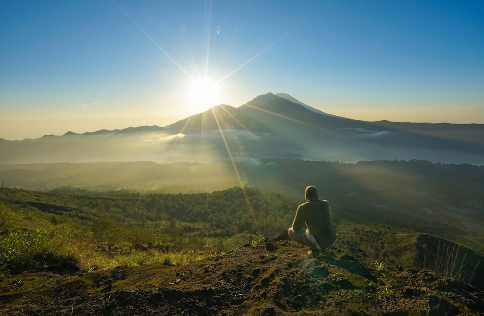 A person watching the sunrise at Mount Batur