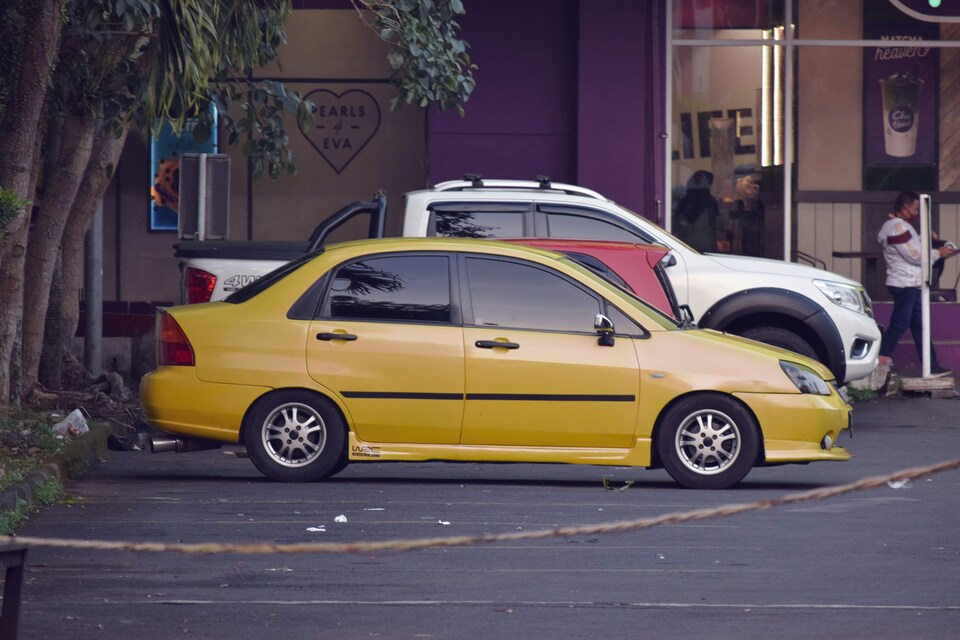 A parked yellow car