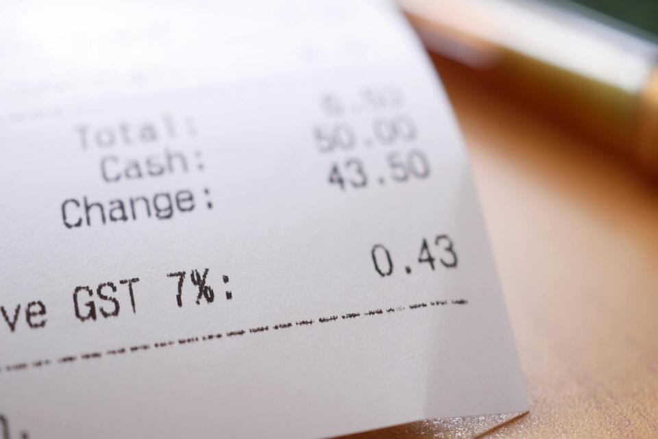 A receipt showing GST and total changes